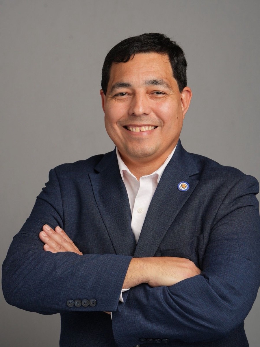 Luis Belén, President & CEO of NHIT, wearing the NHIT lapel pin